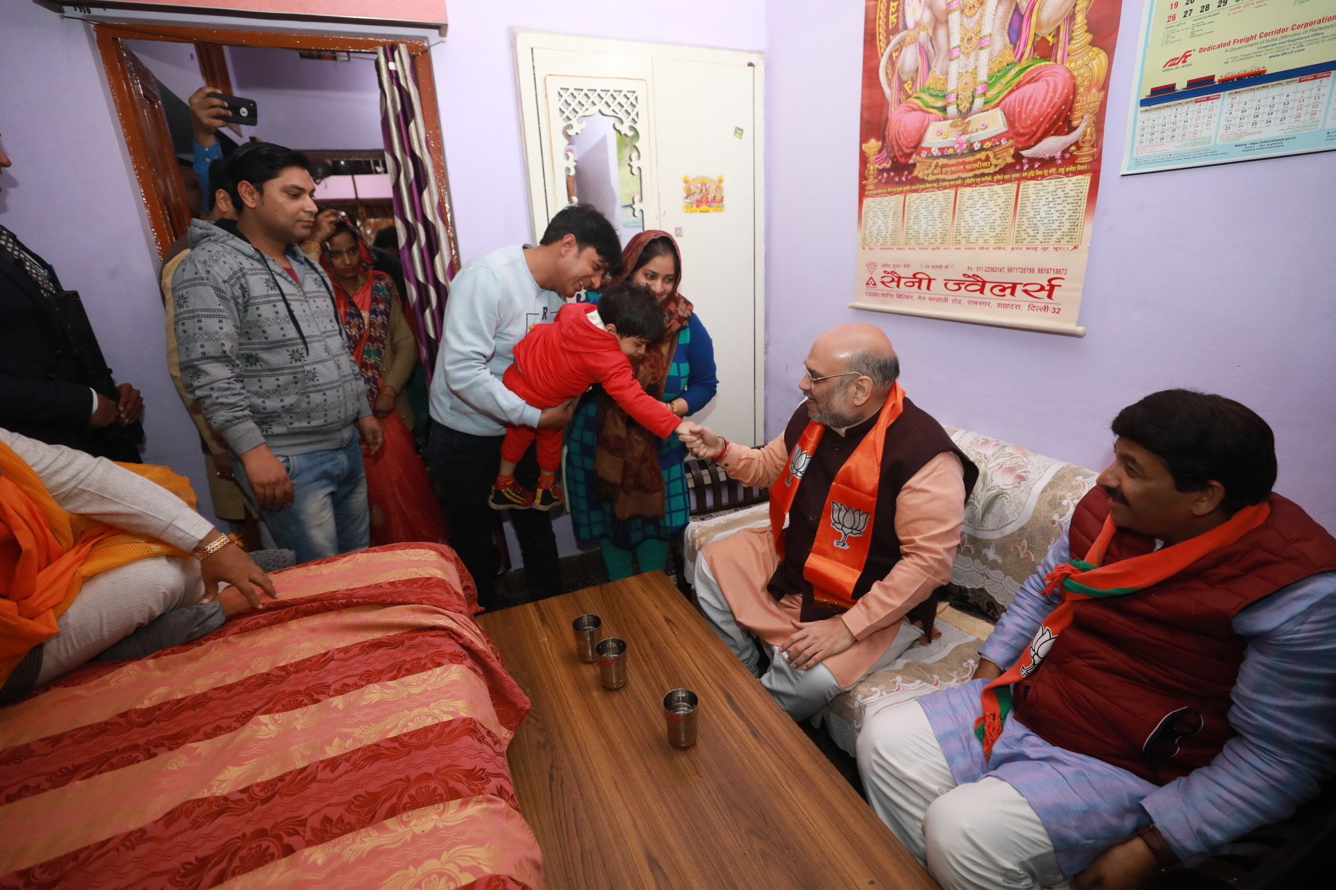 Photographs : Hon'ble Home Minister Shri Amit Shah taking dinner at residence of BJP worker in Yamuna Vihar (Delhi)