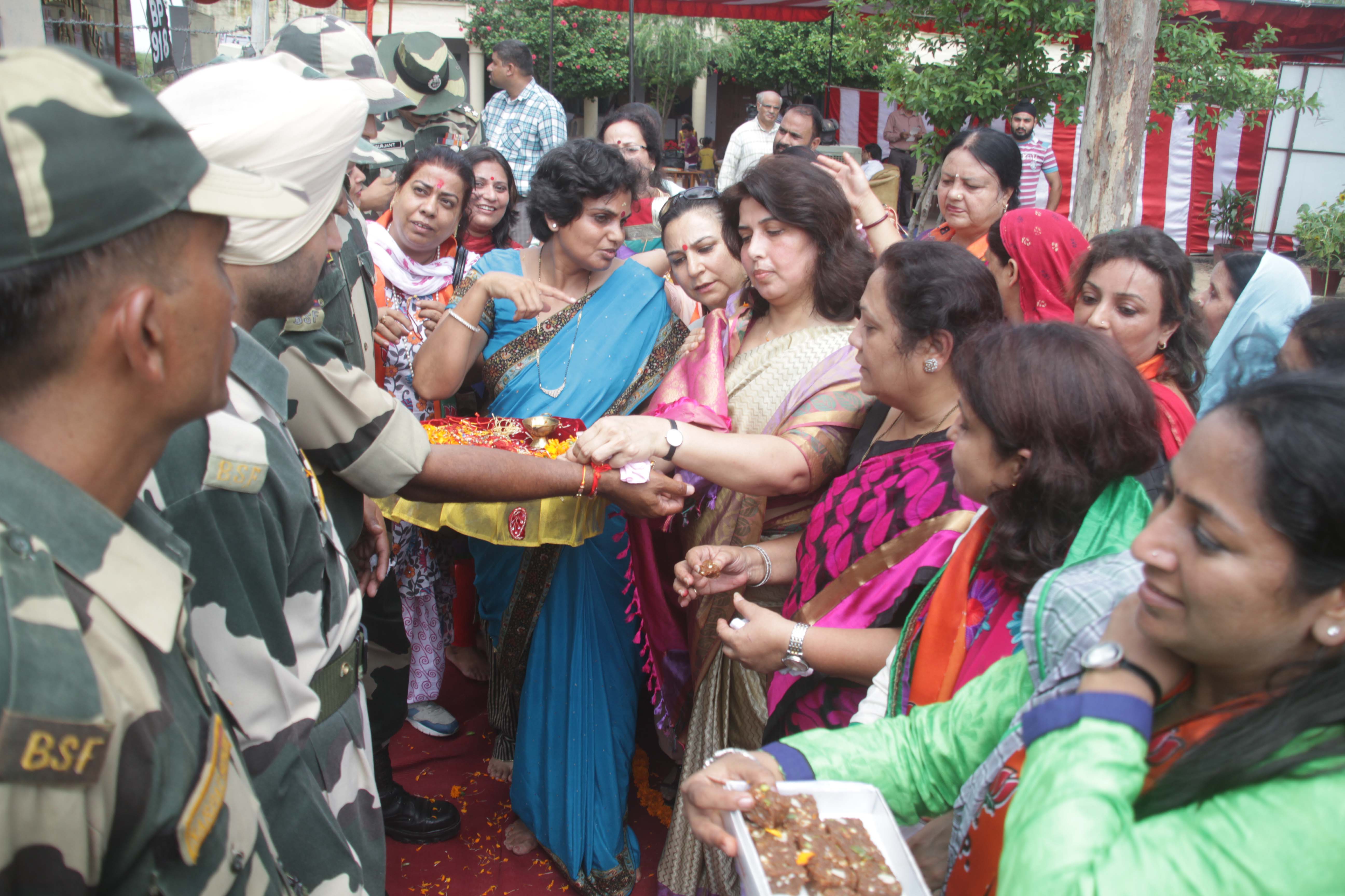 BJP Mahila Morcha President, Sushree Saroj Pandey tying Rakhi to Border Security Force at LOC Suchetgarh (Jammu) on August 21, 2013