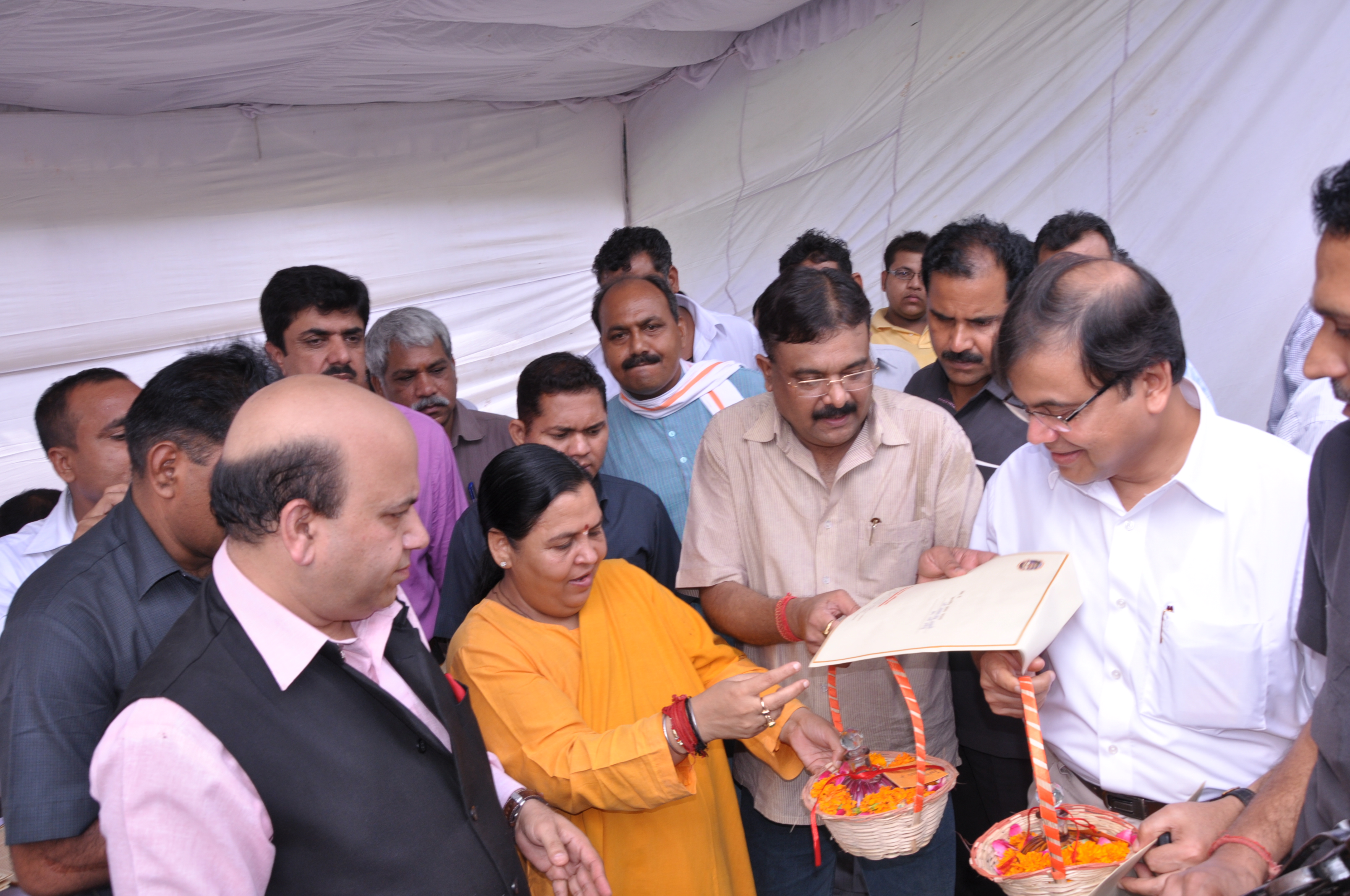 BJP Leader and Convener of Samagra Ganga Abhiyan, Sushri Uma Bharti distributing the Ganga Jal in a sacred pot to MPs at MP Club, North Avenue, New Delhi on August 23, 2012