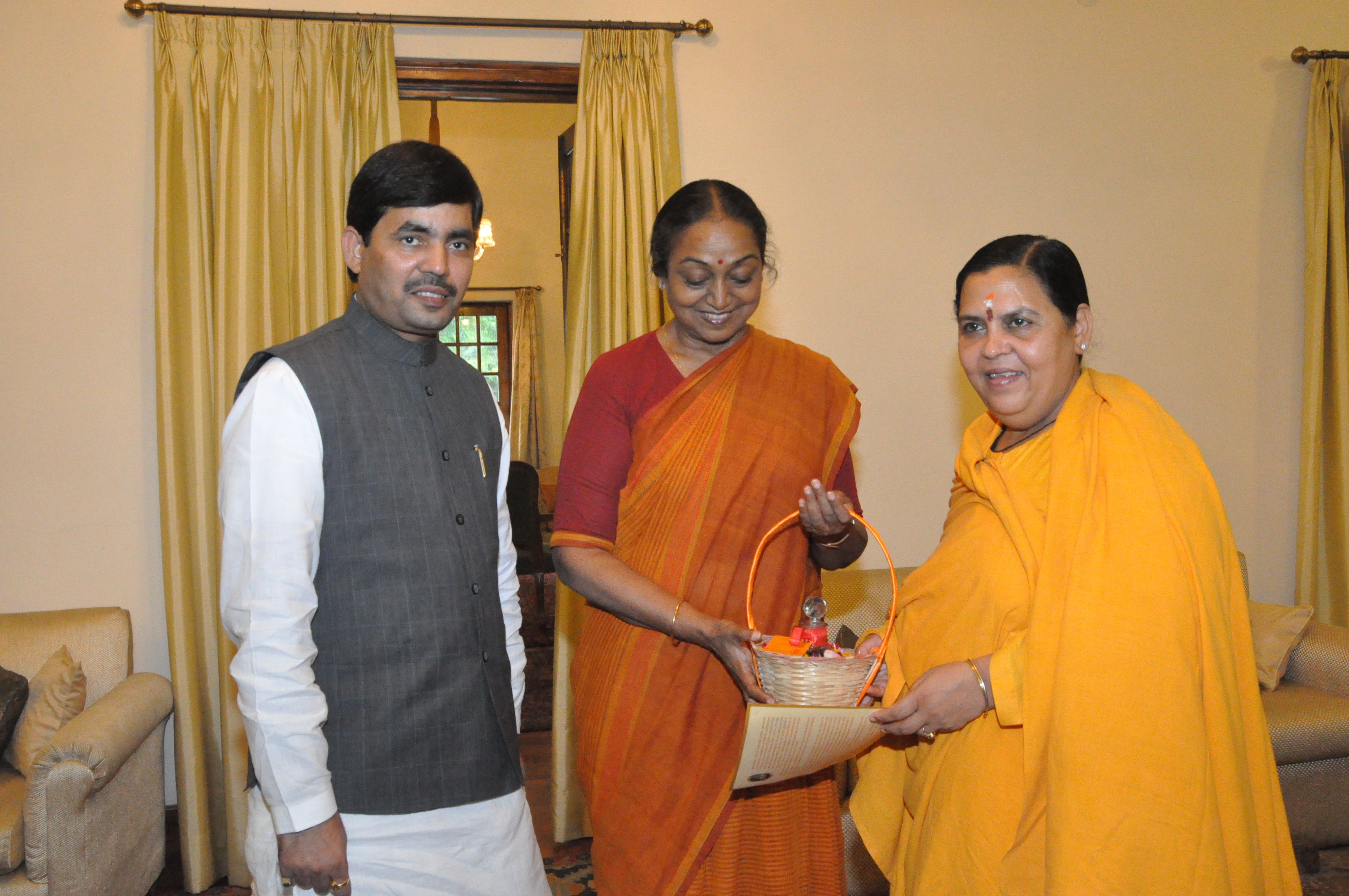 Sushri Uma Bharti along with Syed Shahnawaz Hussain presenting the Ganga Jal in a sacred pot to Lok Sabha Speaker, Smt. Meera Kumar on September 04, 2012