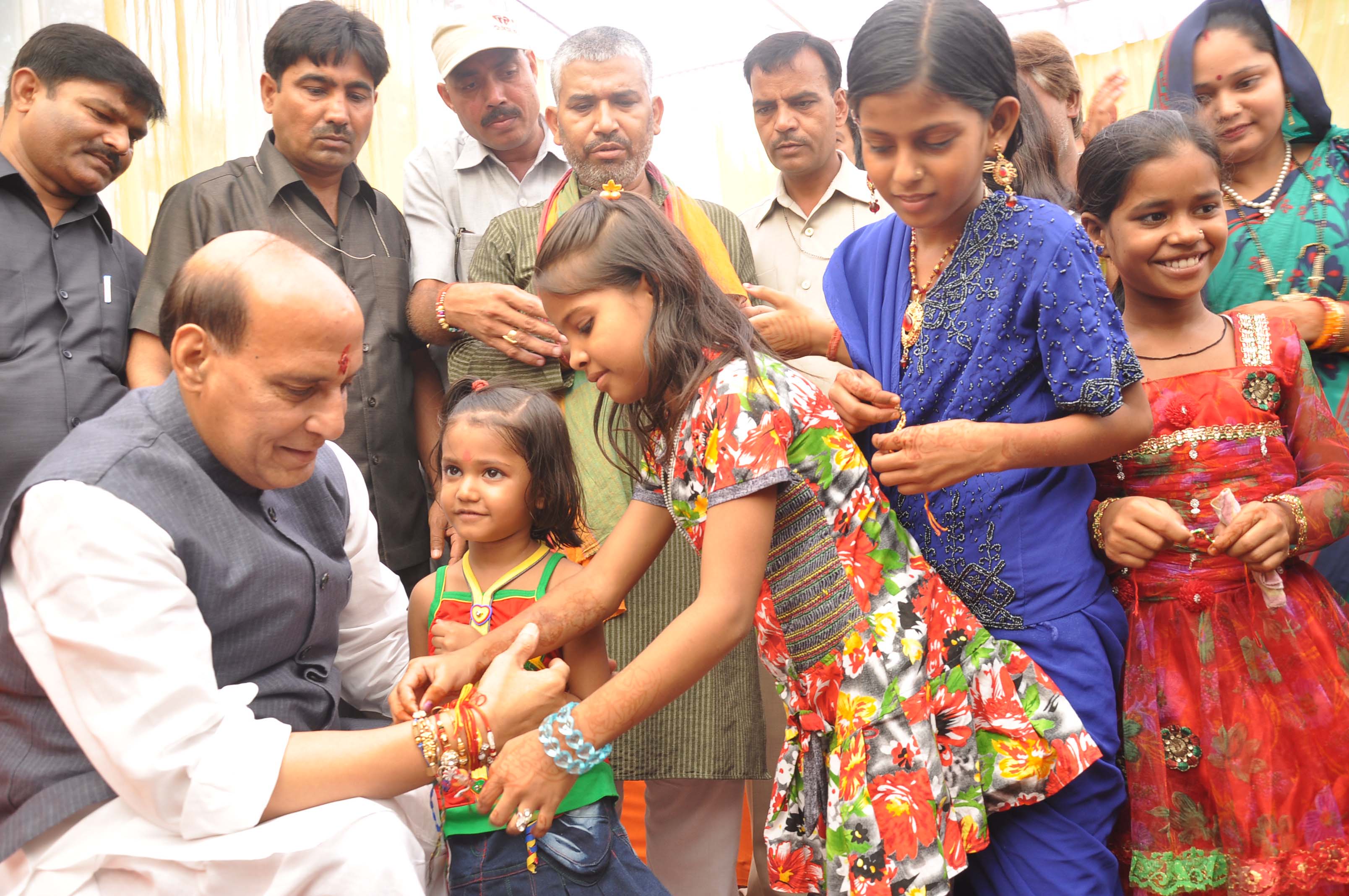 Group of school children tying Rakhi to BJP National President, Shri Rajnath Singh on Rakshabandhan at his residence, 38 Ashok Road, New Delhi on August 21, 2013