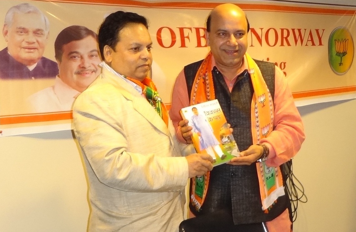 OFBJP leader Vijay Jolly presenting Vikas Ke Path book by BJP President Nitin Gadkari to OFBJP Norway Chief Mohan Singh Varma at Oslo on July 16, 2012