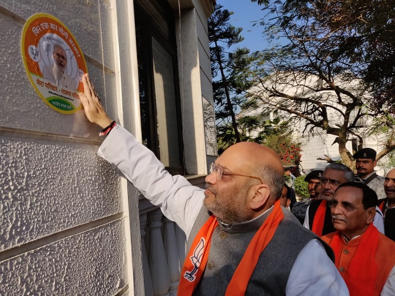   BJP National President Shri Amit Shah pasting 'Mera Parivar-Bhajapa Parivar' sticker at his residence in Ahmedabad (Gujarat).